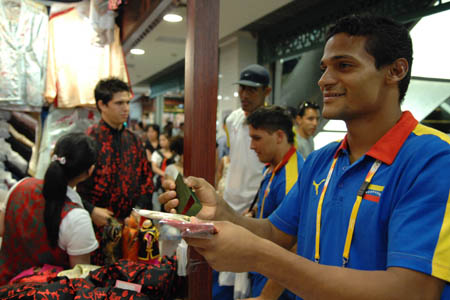 A Venezuelan boxing player shops in Xiushui Market (Silk Street market), a popular tourist market in Beijing