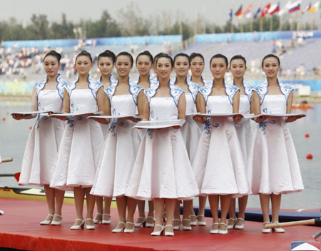 Medal bearers pose during a medal ceremony after rowing finals of the Beijing 2008 Olympic Games at Shunyi Olympic Rowing-Canoeing Park north of Beijing, August 17, 2008.(