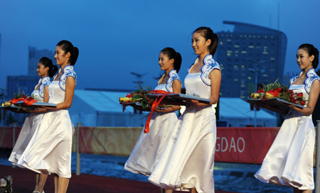 Medal bearers pose during a medal ceremony after rowing finals of the Beijing 2008 Olympic Games at Shunyi Olympic Rowing-Canoeing Park north of Beijing, August 17, 2008.