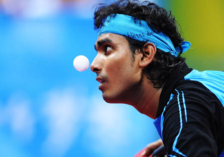 Sharath Kamal Achanta of India serves during the men's singles first round match against Alfredo Carneros of Spain at Beijing Olympic Games table tennis event in Beijing, China, Aug. 19, 2008. Sharath Kamal Achanta of India beat his rival 4-2.(Xinhua/Xu Jiajun)