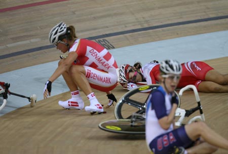 Track cyclist Satomi Wadami of Japan (back), Trine Schmidt of Denmark (L) and Sarah Hammer of the U.S. (front) fall after a crash during the women's points race of the Beijing Olymic Games cycling-track event at Laoshan Velodrome in Beijing, China, Aug. 18, 2008. [Xinhua] 
