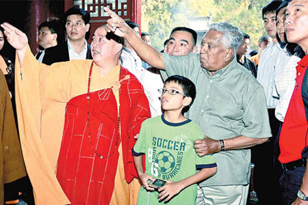 Abbot Yongxin (left) guides Singaporean President S. R. Nathan on a tour of the Shaolin Temple on Sunday. 