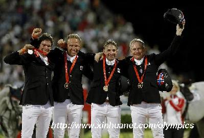 Riders from the team of Norway celebrate during the victory ceremony of the team jumping final of the Beijing 2008 Olympic Games equestrian events in Hong Kong, south China, Aug. 18, 2008. The team of Norway won the bronze medal of team jumping of the Beijing 2008 Olympic Games equestrian events with total penalities of 27. (Xinhua/Zhou Lei)