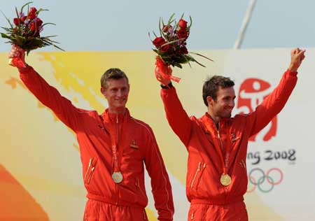 Gold medalists Jonas Warrer (R) and Martin Kirketerp Ibsen of Denmark stand on the podium during the awarding ceremony of the 49er medal race at the Beijing 2008 Olympic Games sailing event at Qingdao Olympic Sailing Center in Qingdao, an-Olympic co-host city in eastern China's Shandong Province, Aug. 18, 2008. [Song Zhenping/Xinhua]