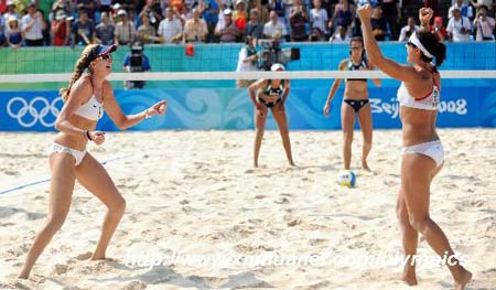Kerri Walsh (front, L) and Misty May-Treanor of the U.S. celebrate a point during the women's semifinal of the Beijing 2008 Olympic Games beach volleyball event against Renata Ribeiro and Talita Rocha of Brazil in Beijing, China, Aug. 19, 2008. 