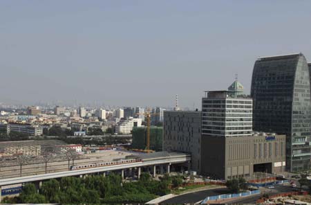 A light rail train leaves Xizhimen Subway Station in Beijing, capital of China, Aug. 19, 2008. Statistics shows that the public traffic sector has registered a passenger transport volume of 20 million persons per day since the control of vehicle use in Beijing last month.[Zhang Shanchen/Xinhua]