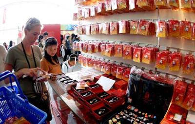 Tourists select the Olympic-related souvenirs 