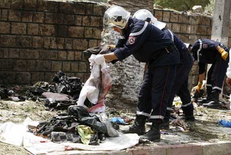 A rescuer clears the site of a suicide bomb attack attack in Issers, 55 km (34 miles) east of Algiers, August 19, 2008. (Xinhua/Reuters Photo)