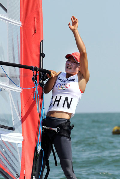 Chinese Yin Jian reacts after winning China's first ever Olympic sailing gold. Yin was crowned champion of RS:X Women at the Olympic Sailing Regatta here on Wednesday. [Song Zhenping/Xinhua]