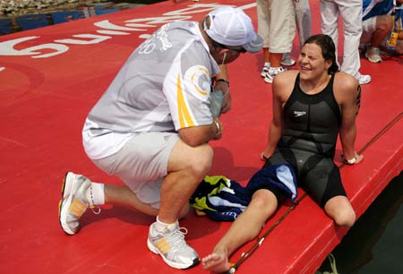 Natalie Du Toit of South Africa talks to her coach after women's marathon 10km competition at the Beijing 2008 Olympic Games swimming event in Beijing, China, Aug. 20, 2008. Natalie Du Toit ranked the 16th of the event. Du Toit, whose left leg was amputated in 2001 after she was injured in a road accident, is an athlete for both Beijing 2008 Olympic Games and Paralympic Olympics. (Xinhua/Liu Dawei)