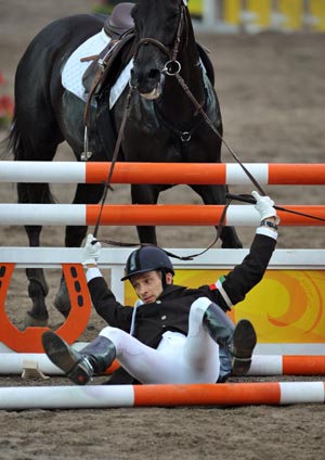 Viktor Horvath of Hungary falls when competing during the men's riding show jumping match of the Beijing 2008 Olympic Games modern pentathlon event in Beijing, China, Aug. 21, 2008. Viktor Horvath ranked 19th in the men's modern pentathlon.