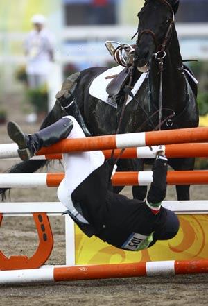 Viktor Horvath of Hungary falls when competing during the men's riding show jumping match of the Beijing 2008 Olympic Games modern pentathlon event in Beijing, China, Aug. 21, 2008. Viktor Horvath ranked 19th in the men's modern pentathlon.