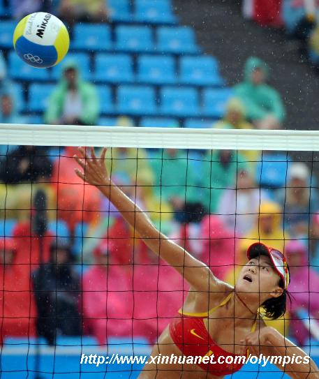 Xue Chen of China spikes during the women's bronze medal match against Renata Ribeiro and Talita Rocha of Brazil of the Beijing 2008 Olympic Games beach volleyball event in Beijing, China, Aug. 21, 2008. Xue Chen and Zhang Xi of China won the match 2-0 and got the bronze medal. [Gaesang Dawa/Xinhua]