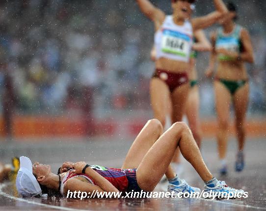 Norway's Kjersti Tysse Platzer lies on the track after women's 20km walk final at the National Stadium, also known as the Bird's Nest, during Beijing 2008 Olympic Games in Beijing, China, Aug. 21, 2008. Kjersti Tysse Platzer won the silver with 1:27:07. [Guo Dayue/Xinhua]