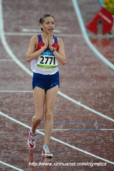 Russia's Olga Kaniskina reacts after corssing the finish line during women's 20km walk final at the National Stadium, also known as the Bird's Nest, during Beijing 2008 Olympic Games in Beijing, China, Aug. 21, 2008. Russia's Olga Kaniskina claimed the title of the event with 1:26:31 and set a new Olympic record. [Guo Yong/Xinhua]