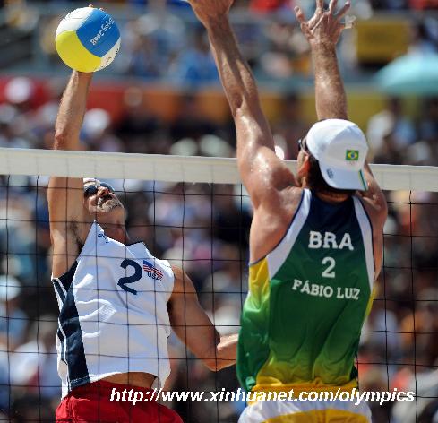 Todd Rogers (L) of the United States spikes the ball over Fabio Magalhaes of Brazil during the beach volleyball gold medal match at the Beijing Olympic Games in Beijing, China, Aug. 22, 2008. Philip Dalhausser/Todd Rogers of the United States defeated Marcio Araujo/Fabio Magalhaes of Brazil and grabbed the gold medal of the event. [Sadat/Xinhua]