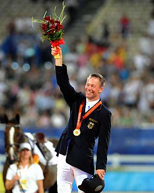 German rider Hinrich Romeike waves on the podium during the awarding ceremony for the individual eventing of the Beijing 2008 Olympic Games equestrian events in the Olympic co-host city of Hong Kong, south China, Aug. 13, 2008. Hinrich Romeike won the gold medal with a total penalty of 54.20. [Lo Ping Fai/Xinhua]