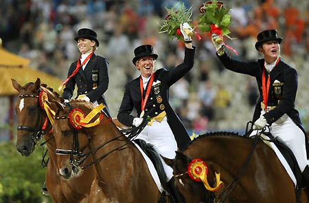 The team of Germany celebrate after receiving gold medals of dressage team final of Beijing 2008 Olympic equestrian events in the Olympics co-host city of Hong Kong, south China, Aug. 14, 2008. Germany won the Olympic team dressage gold medal, their 7th successive Olympic title, in Hong Kong Thursday night. [Zhou Lei/Xinhua]