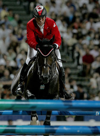 Canadian rider Eric Lamaze jumps his horse Hickstead over an obstacle during the individual jumping final of the Beijing 2008 Olympic Games equestrian events in Hong Kong, China, Aug. 21, 2008. [Zhou Lei/Xinhua]