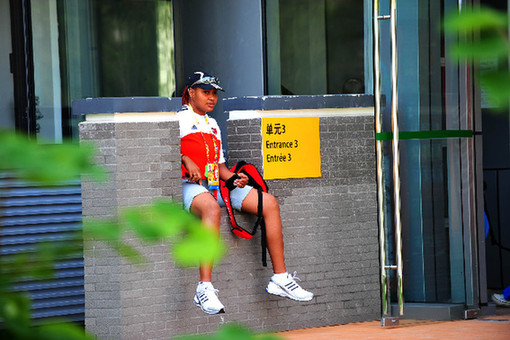 An athlete waited for her partner outside the apartment in the Olympic Village on August 23, 2008. [Xinhua]
