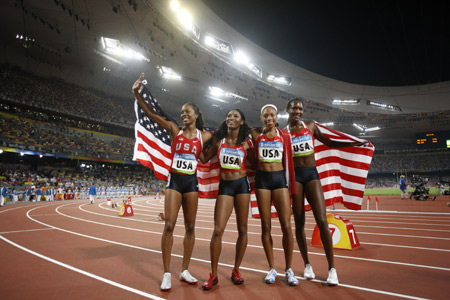 Runners of the United States celebrate after the women's 4x400m relay final at the National Stadium, also known as the Bird's Nest, during Beijing 2008 Olympic Games in Beijing, China, Aug. 23, 2008. The team of the United States won the title with 3:18.54. [Liao Yujie/Xinhua] 