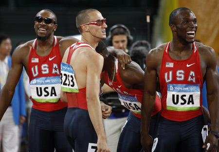 Runners of the United States react after the men's 4x400m relay final at the National Stadium, also known as the Bird's Nest, during Beijing 2008 Olympic Games in Beijing, China, Aug. 23, 2008. The team of the United States won the title with 2:55.39 and set a new Olympic record. [Liao Yujie/Xinhua]
