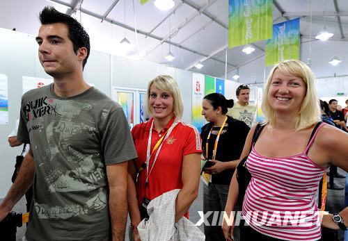 Canadian visitors wait to enter the Olympic Village on Friday, August 22, 2008. [Photo: Xinhuanet]