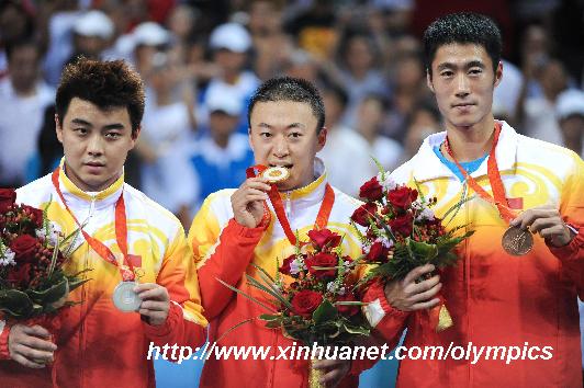 Ma Lin (C), Wang Hao (L) and Wang Liqin of China attend the awarding ceremony of Men's Singles of Beijing 2008 Olympic Games table tennis event at PKU Gymnasium in Beijing, China, Aug. 23, 2008. Ma Lin, Wang Hao and Wang Liqin won the gold, silver and bronze medal of the event respectively. [Xinhua]