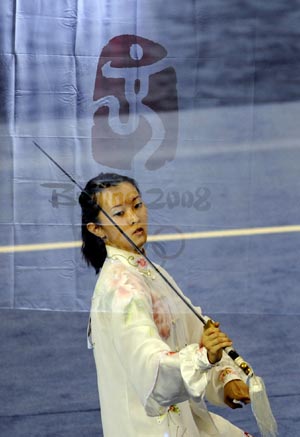 This mutiple-exposal photo taken on Aug. 23, 2008 shows Chai Fong Ying of Malaysia performing in the Taijijian section of women's Taijiquan and Taijijian combined competition of Beijing 2008 Wushu tournament, in Beijing, China. She won the silver medal of the event wtih 19.34 points. [Xinhua] 