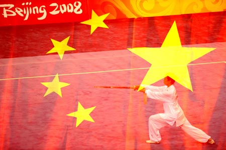 This mutiple-exposal photo taken on Aug. 23, 2008 shows Cui Wenjuan of China performing in the Taijijian section of women's Taijiquan and Taijijian combined competition of Beijing 2008 Wushu tournament, in Beijing, China. She won the gold medal of the event wtih 19.69 points.[Xinhua]