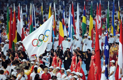 Flags representing all the participating countries line up at the center of the stadium, ready for the closing ceremony. [Xinhua]