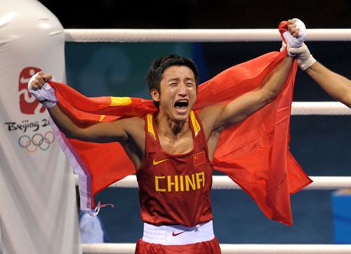 Zou Shiming revels in his victory in the light flyweight boxing final on Sunday. [XInhua] 