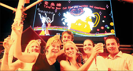 Foreigners enjoy Tsingtao beer at the Beer Street in Qingdao during the Olympic sailing competition.