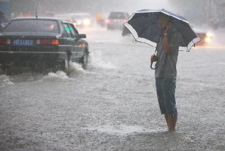 Flights delayed, roads flooded as downpours hit Shanghai