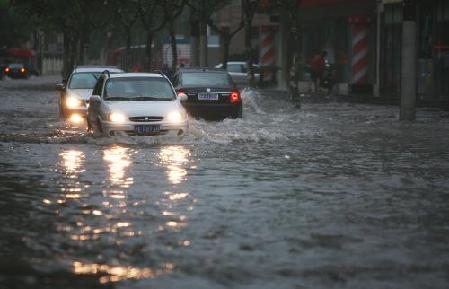 Flights delayed, roads flooded as downpours hit Shanghai