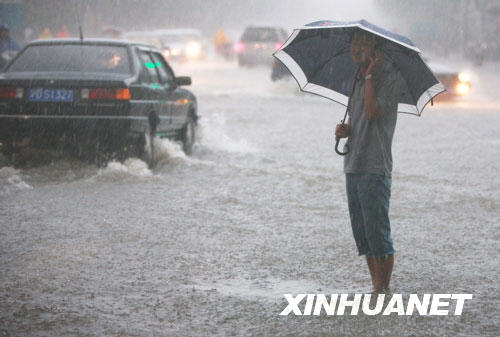 roads flooded as downpours drench Shanghai.