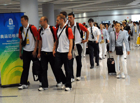 Members of different Olympic delegations walk to a frontier inspection counter at the Beijing Capital International Airport in Beijing, capital of China, Aug. 25, 2008. The airport saw a peak traffic volume on Monday as many Olympic delegations left the Chinese capital. A total of 32,596 passengers would leave Beijing throughout the day, doubling the usual figure. (Xinhua/Tang Zhaoming)