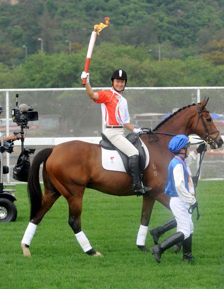 Photo: Equstrian Nelson Yip Siu-hong with a disability relays the torch on a horse