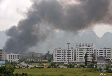 Smoke rises as rescue operation goes on at the exploded chemical plant on the outskirts of Yizhou City, southwest China's Guangxi Zhuang Autonomous Region, Aug. 26, 2008.