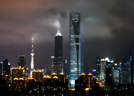 Undated file photo of a view of the Shanghai World Financial Center (C) at night in Shanghai. Observation decks on 100th and 97th floors of the 101-storey tower, overlooking the city, are set to be finished and open to the public at the end of this month, providing visitors a spectacular view of downtown Shanghai and the winding Huangpu River. [file]