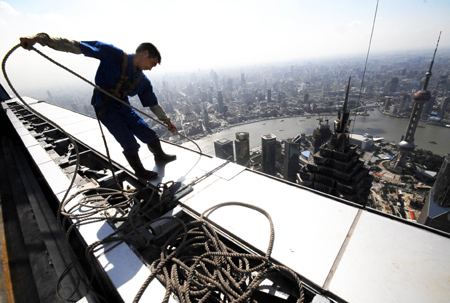 A construction worker works on the 492-meter-tall Shanghai World Financial Center under construction in Shanghai, August 26, 2008. 