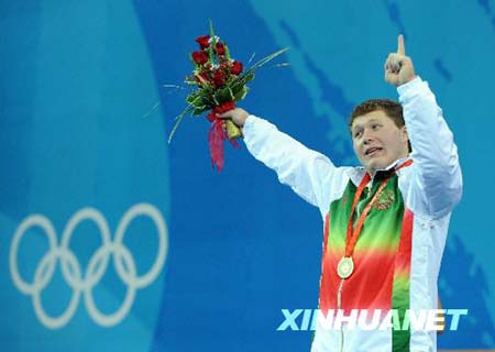 Gold medalist Andrei Aramnau of Belarus poses on the podium during the awarding ceremony of men's 105 kg of Beijing 2008 Olympic Games Weightlifting event in Beijing, China, Aug. 18, 2008.