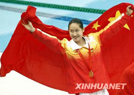 Liu Zige of China displays Chinese national flag after the awarding ceremony of women's 200m butterfly at the Beijing 2008 Olympic Games in the National Aquatics Center, also known as the Water Cube in Beijing, China, Aug. 14, 2008. Liu won the gold medal with a new world record of 2 minutes 4.18 seconds.
