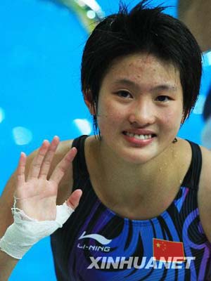 Chinese diver Chen Ruolin waves to spectators during the awarding ceremony of women's 10m platform at the Beijing 2008 Olympic Games in the National Aquatics Center, also known as the Water Cube in Beijing, China, Aug. 21, 2008. Chen claimed the title in the event with a score of 447.70 points.