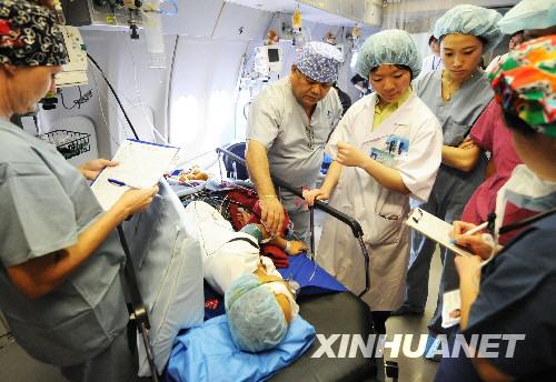 Medical staff on the &apos;Flying Eye Hospital&apos; examine a patient who has just received eye surgery on Wednesday, August 27, 2008. [Photo: Xinhuanet] 