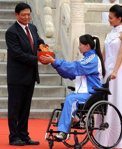Liu Qi, president of the organizing committee of the just concluded Beijing Olympic Games, lights the torch. 
