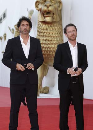 U.S. directors Joel (L) and Ethan Cohen pose as they arrive for the red carpet of the Film Festival in Venice August 27, 2008.