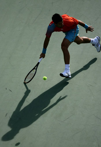 Novak Djokovic of Serbia returns the ball against Arnaud Clement of France during the first round competition of men's singles at US Open tennis in New York, Aug. 27, 2008. Novak Djokovic beat Arnaud Clement 6-3, 6-3, 6-4. 