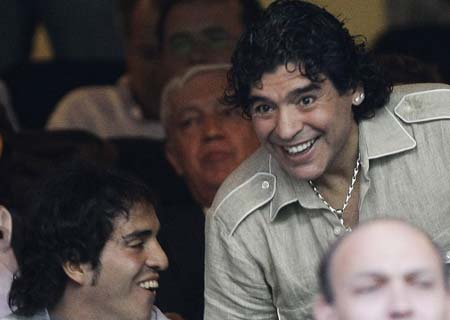 Argentine former soccer star Diego Armando Maradona (R) attends the Atletico Madrid-Schalke 04 Champions League third qualifying round, second leg soccer match, at the Vicente Calderon stadium in Madrid August 27, 2008. 