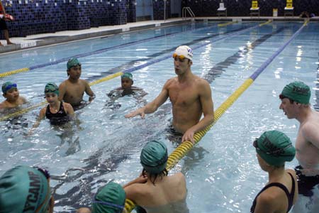 Olympic gold medallist Michael Phelps teaches swimming exercise techniques with children at the YMCA of Greater New York in New York August 28, 2008. 